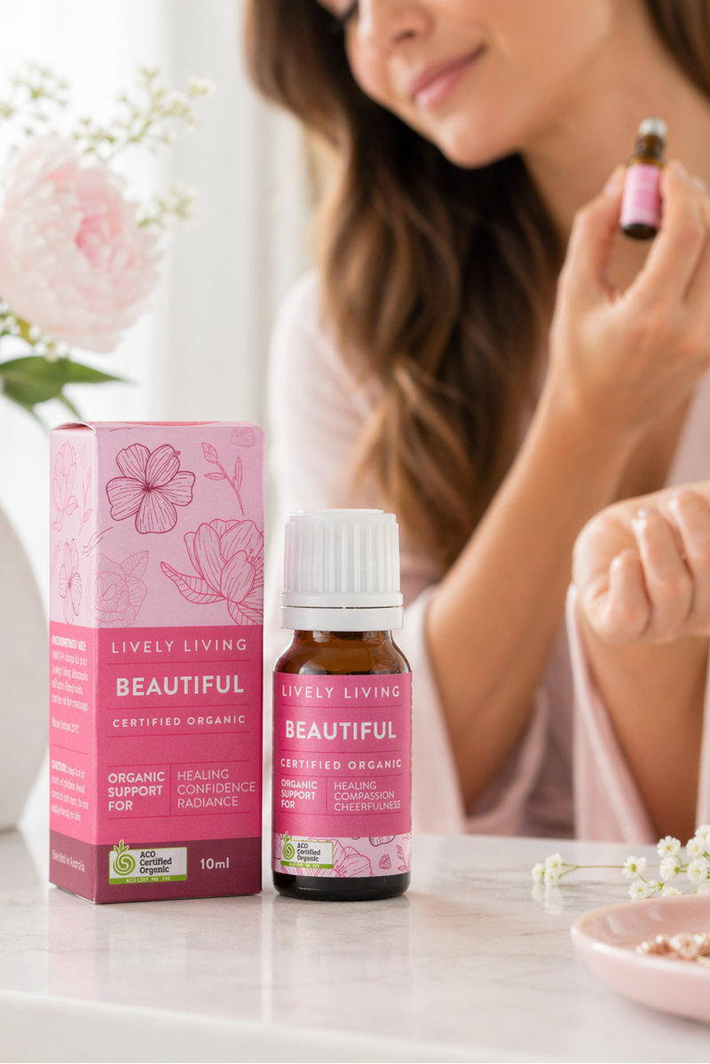 Woman applying a product from Lively Living to her face with a pink box and bottle on a table.
