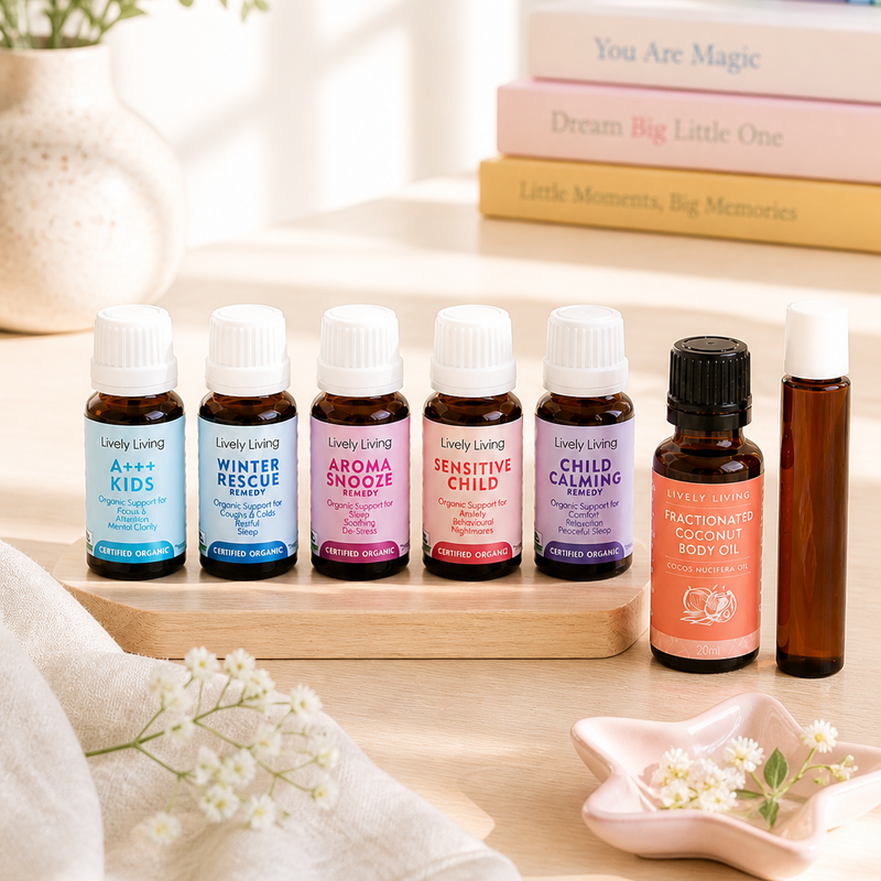 Collection of essential oil bottles on a wooden tray with a rainbow decoration in the background.