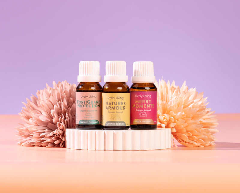 Three essential oil bottles with labels on a gradient background