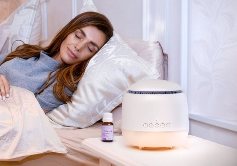Woman lying in bed with a diffuser and bottle of essential oil on a nightstand.