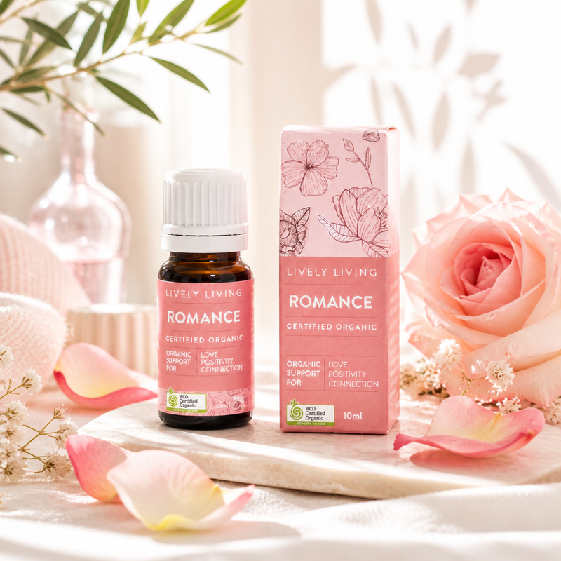 Lively Living Romance essential oil bottle and packaging with flowers and petals on a soft background