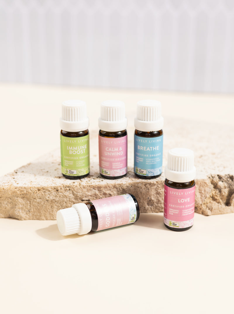 Set of essential oil bottles on a light surface with a neutral background