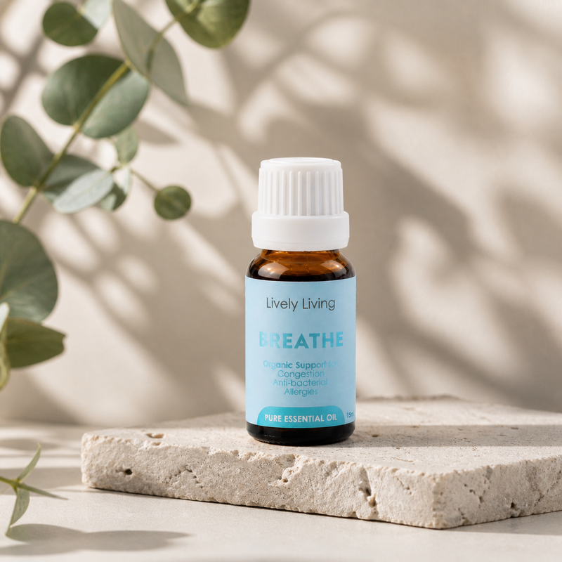 Lively Living Breathe essential oil bottle on a light surface with eucalyptus leaves in the background