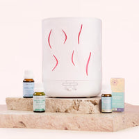White diffuser with decorative lines on a stone surface with essential oil - Lively Living 