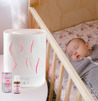 Aroma-Cloud diffuser and an essential oil next to baby sleeping