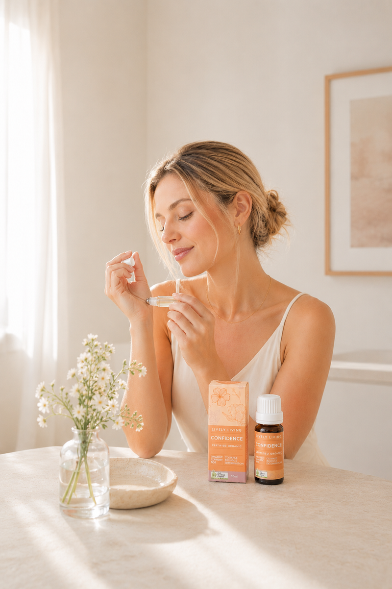 Woman applying cream to her face with skincare products on a table.