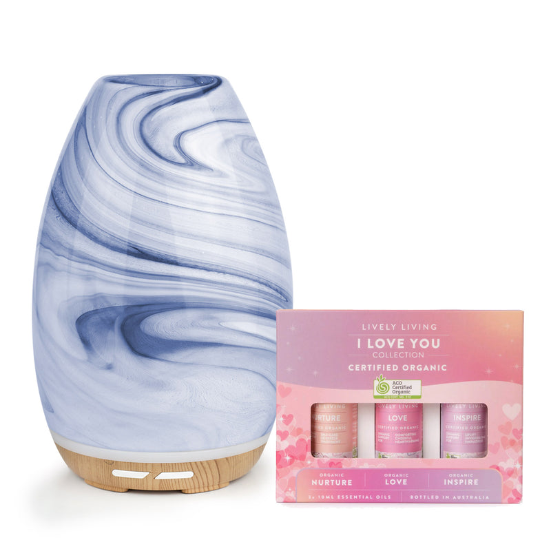 Marble-patterned diffuser with a box of Lively Living essential oils on a white background