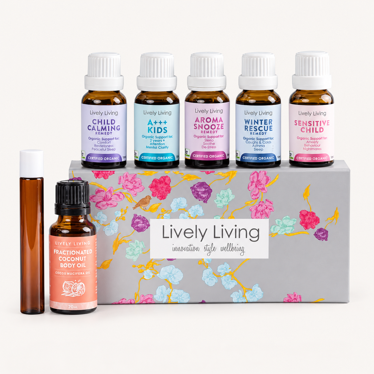 Lively Living Kids Organic Oil Kit on a white background: Child Calming, A++ Kids, Aroma Snooze, Winter Rescue and Sensitive Child 15ml oils on the floral gift box, with a roll-on bottle and coconut oil in front