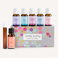Lively Living Kids Organic Oil Kit on a white background: Child Calming, A++ Kids, Aroma Snooze, Winter Rescue and Sensitive Child 15ml oils on the floral gift box, with a roll-on bottle and coconut oil in front