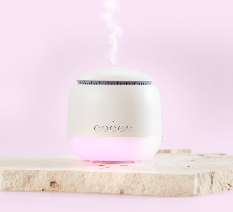 White humidifier on a light pink background