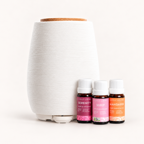 White ceramic Aroma-Fern diffuser with a bamboo lid beside Lively Living Serenity, Sleep and Mandarin oils from the Sleep Sanctuary Trio
