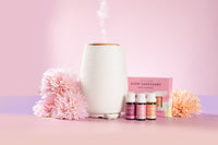 Livley Living Aroma-Fern diffuser with essential oil bottles and packaging on a pink background