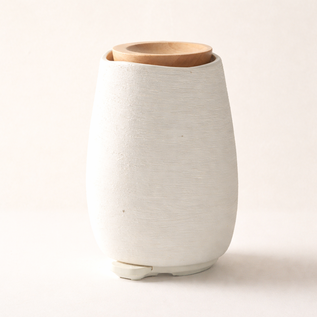 White ceramic vase with a wooden lid on a light beige background