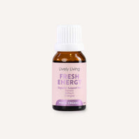 A small amber glass bottle with a white ribbed cap and a pale pink label reading 'Lively Living Fresh Energy Organic Support Formula' on a light beige background.
