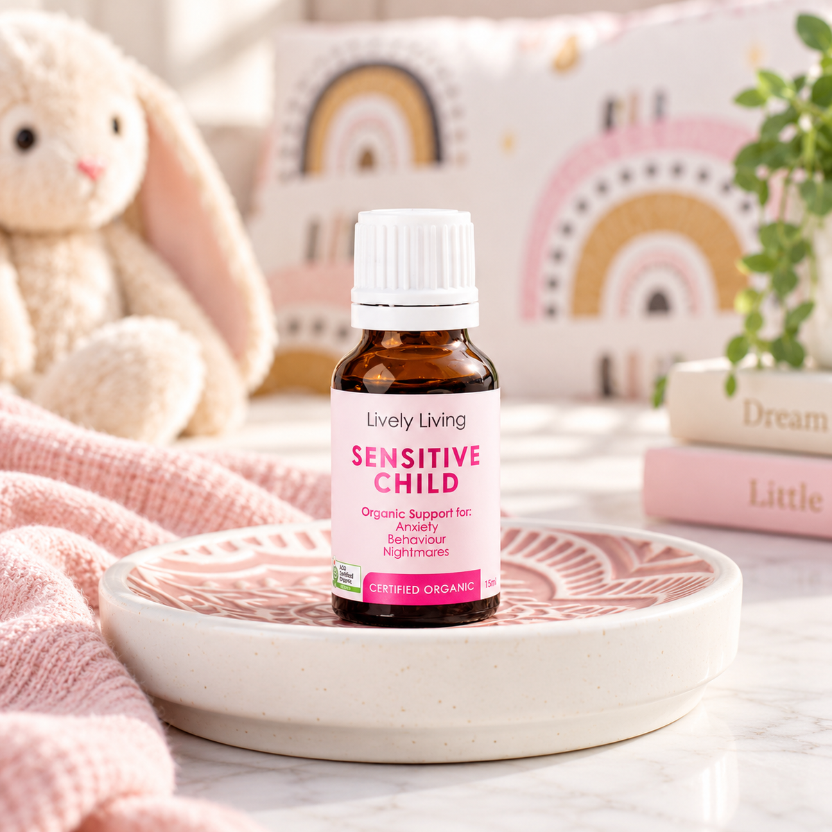 Sensitive Child essential oil on a pink patterned dish in a child's bedroom with a toy bunny