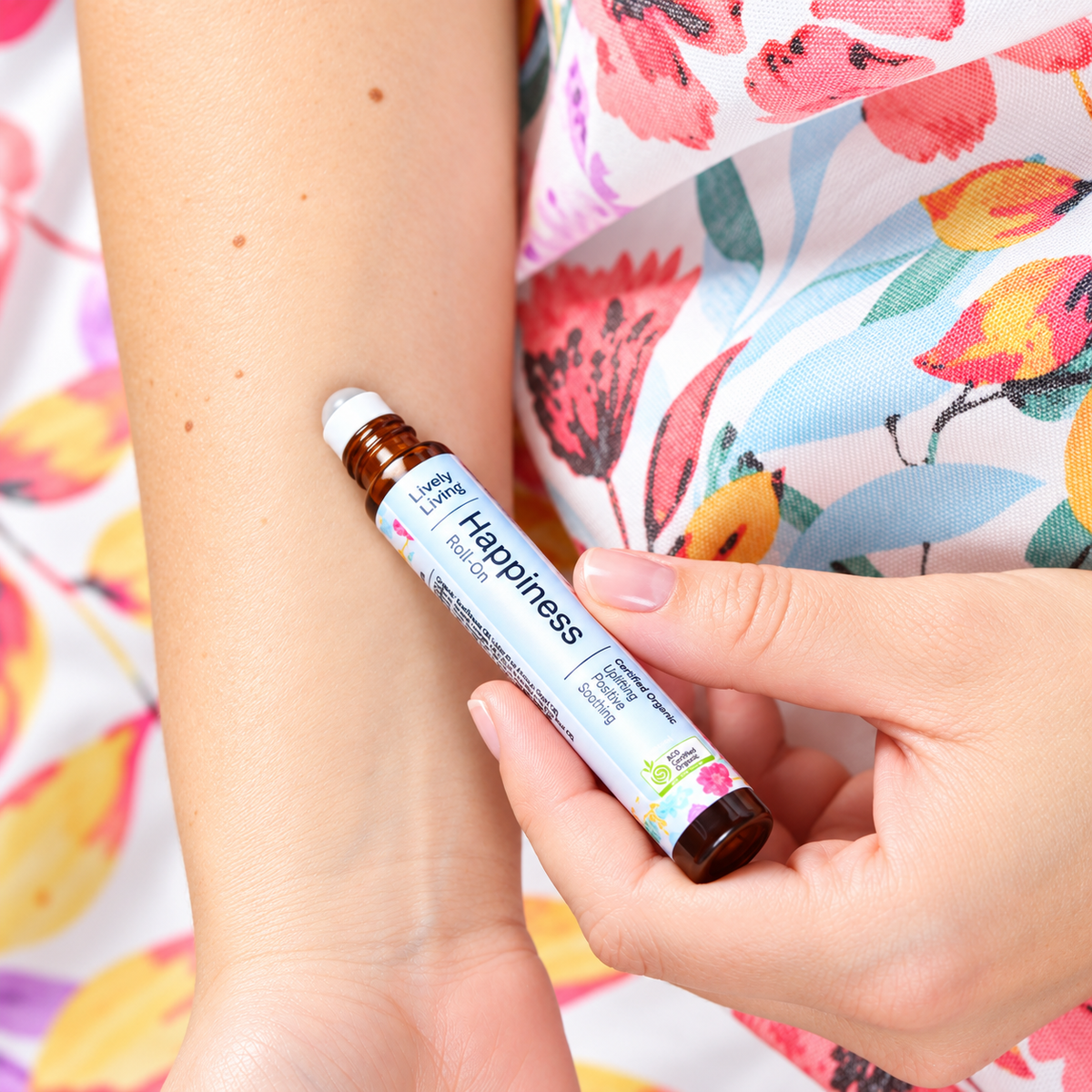 Lively Living Happiness organic essential oil roll-on among flowers