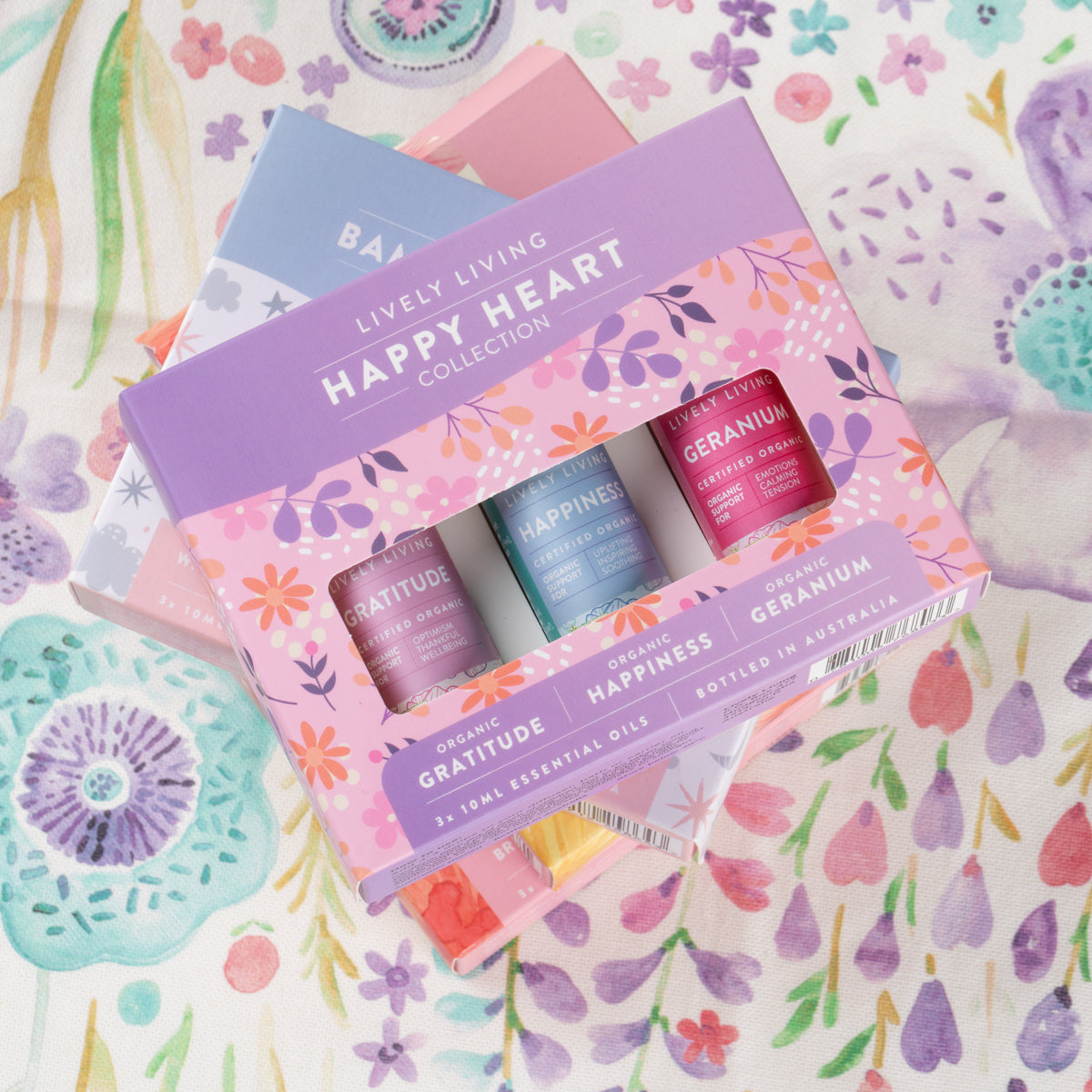 Happy Heart Collection gift box lying on a pastel floral print