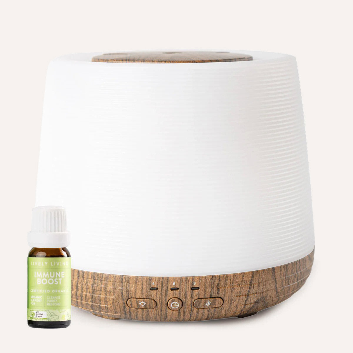White diffuser with wooden accents and a bottle of 'Immune Boost' essential oil on a white background