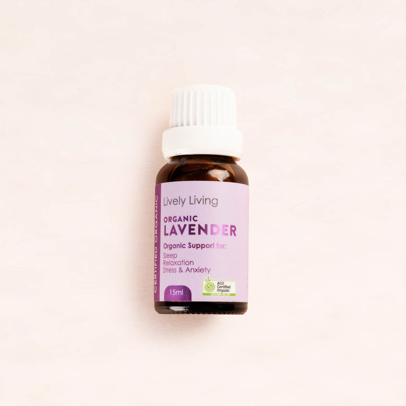 Lively Living Organic Lavender essential oil bottle on a light pink background