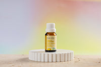 Lemon essential oil by Lively Living on white stand 