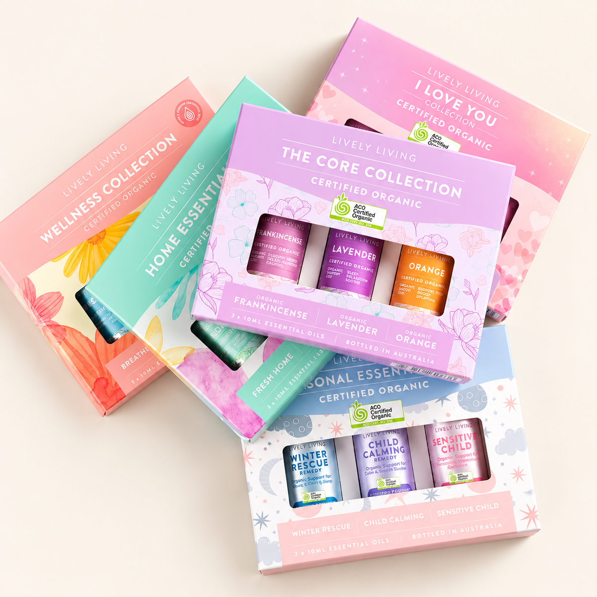 Flat lay of Lively Living gift boxes, with The Core Collection of Frankincense, Lavender and Orange on top and a box of Winter Rescue, Child Calming and Sensitive Child below