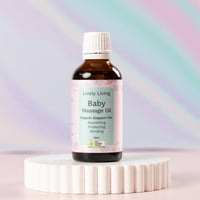 Baby Massage Oil Organic Lively Living, sitting on a rippled white base, with a multi coloured background
