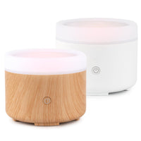 Two night lights, one wooden and one white, on a white background