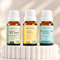 Lively Living Organic Tea Tree, Organic Lemon and Protection Blend 15ml essential oils side by side on a white fluted pedestal in soft natural light