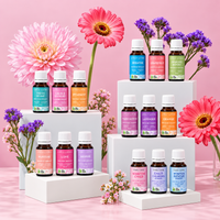 Lively Living certified organic oil range including Breathe, Lavender, Love and Winter Rescue on tiered white blocks with pink flowers