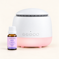 White Aroma-Snooze with a pink base beside a bottle of Lively Living Pet Calm certified organic essential oil on a cream background
