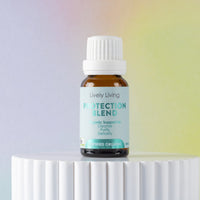 Bottle of Lively Living Protection Blend on a white pedestal with a gradient background