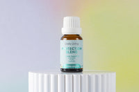 Bottle of Lively Living Protection Blend on a white pedestal with a gradient background