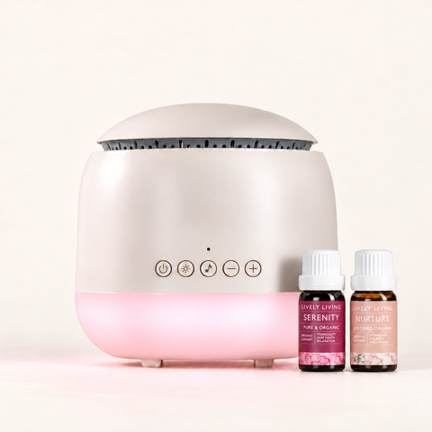 Aroma-Frequency Sound Diffuser with a soft pink glow beside Lively Living Serenity and Nurture oils from the Calm Bundle