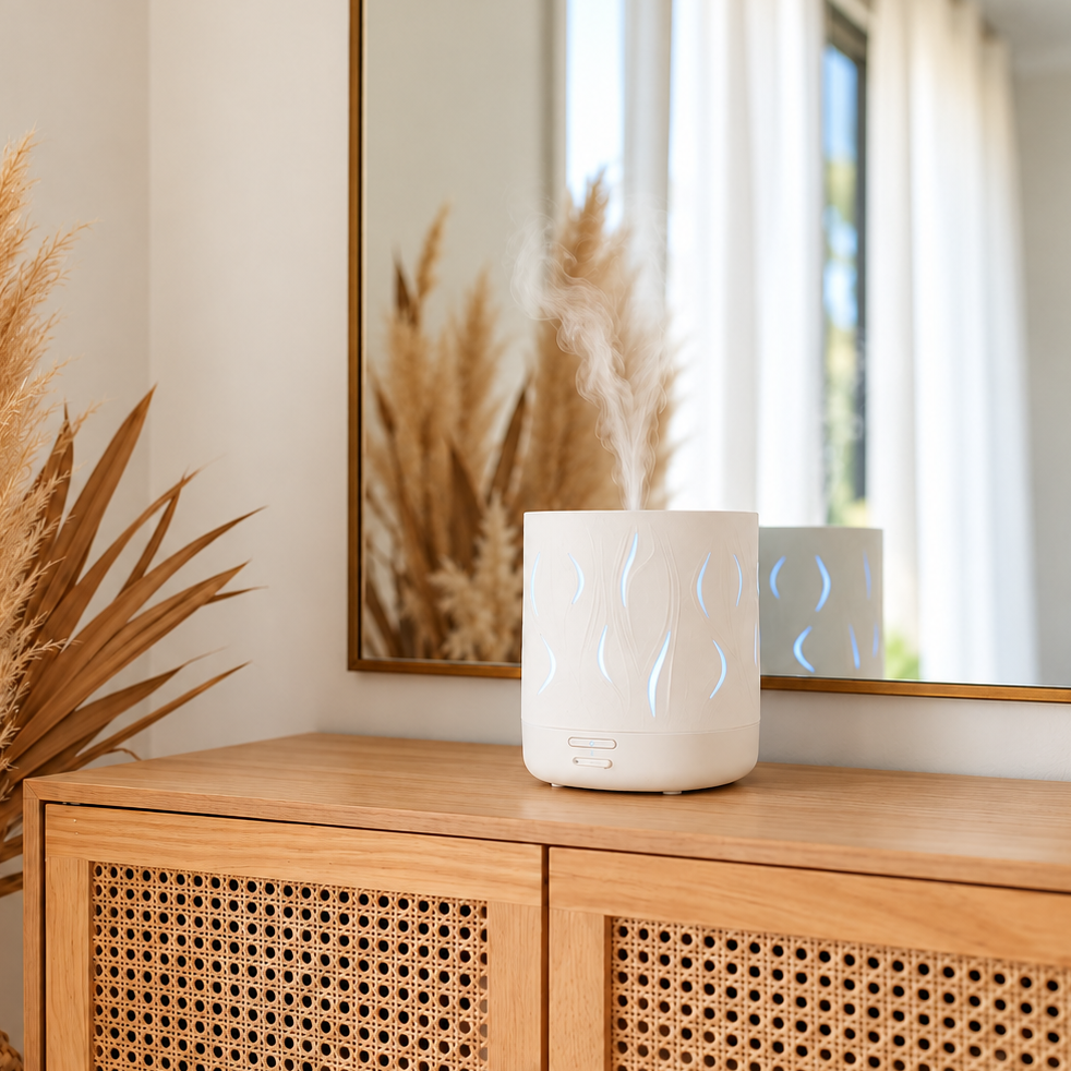 White Aroma-Cloud diffuser with wave-shaped cut-outs on a light timber sideboard with woven cane doors, in a warm modern room with a large mirror and dried pampas grass