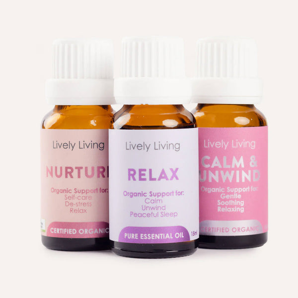 Three bottles of Lively Living essential oils labeled 'Nurture', 'Relax', and 'Calm & Unwind' on a white background.