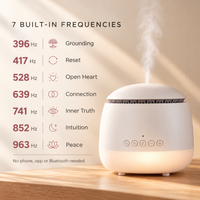 White Aroma-Frequency Sound Diffuser releasing mist on a wooden shelf, beside a list of its 7 built-in frequencies from 396 Hz to 963 Hz: Grounding, Reset, Open Heart, Connection, Inner Truth, Intuition and Peace. No phone, app or Bluetooth needed.