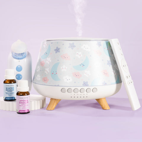 A pastel-colored diffuser and humidifier set on a light purple background, featuring a moon-and-stars patterned diffuser, a white humidifier bottle, two small essential oil bottles, and a white remote control.