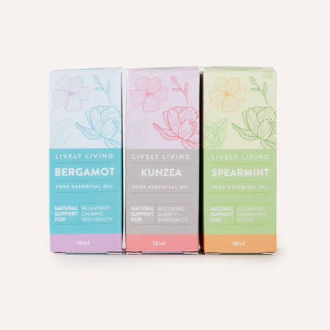 Three colorful boxes of Lively Living essential oils on a white background