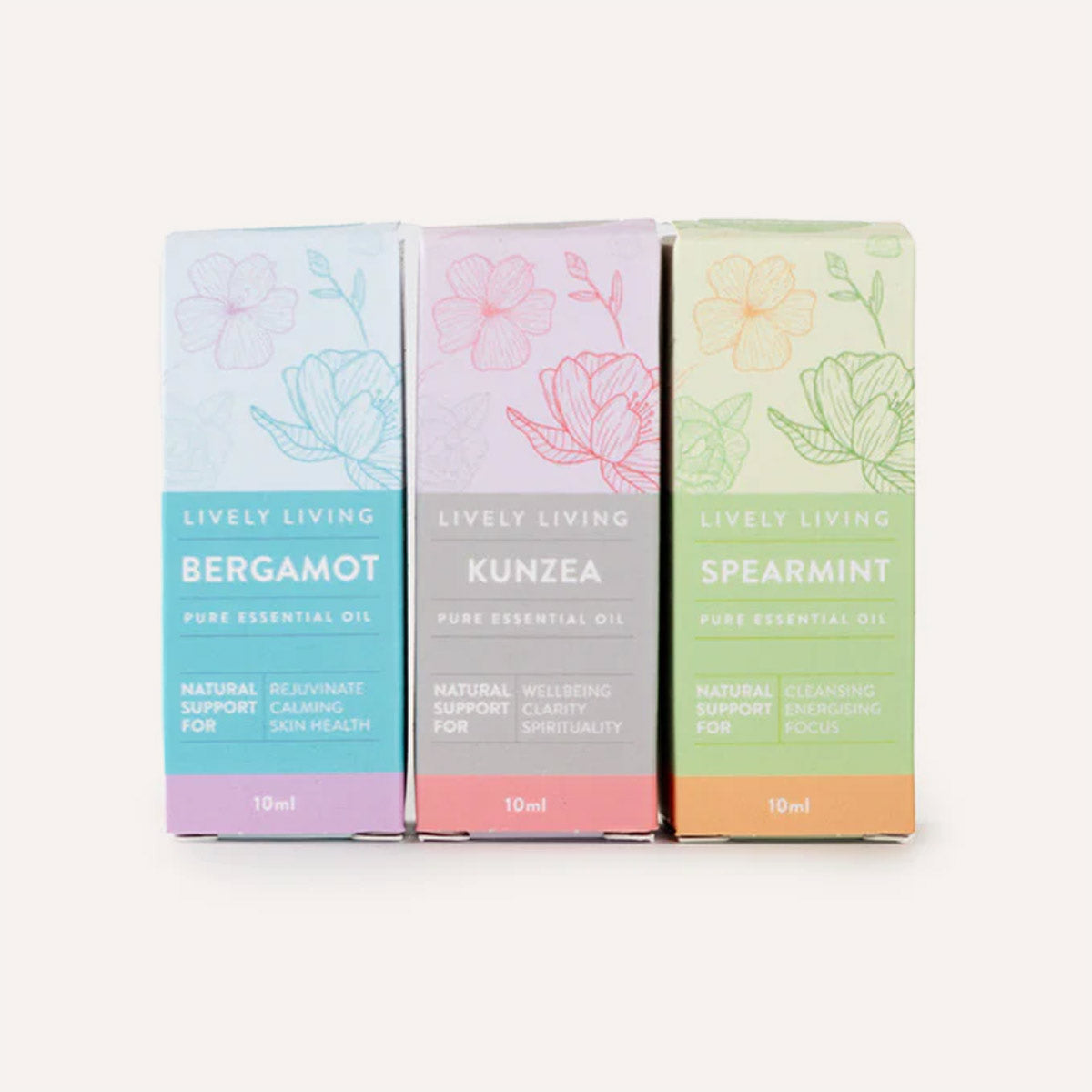 Three colorful boxes of Lively Living essential oils on a white background