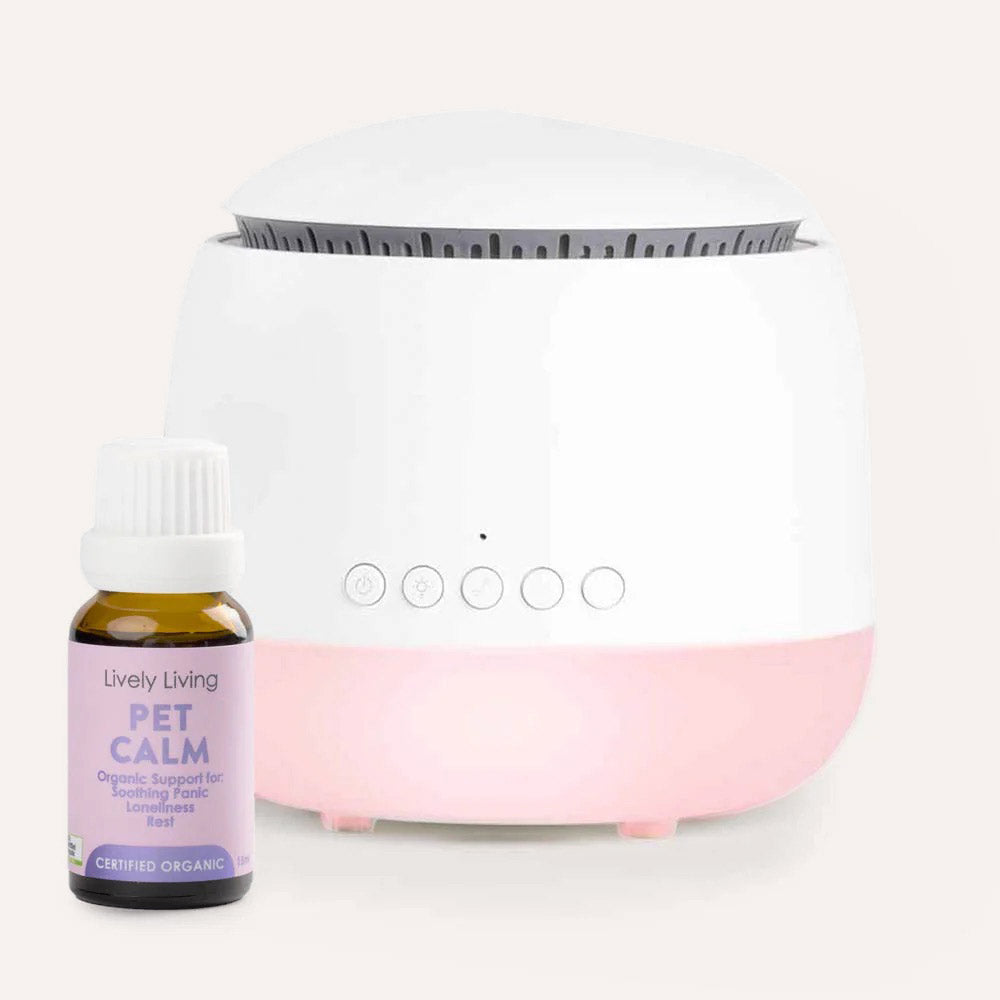 White diffuser with pink base and a bottle labeled 'Pet Calm' on a white background