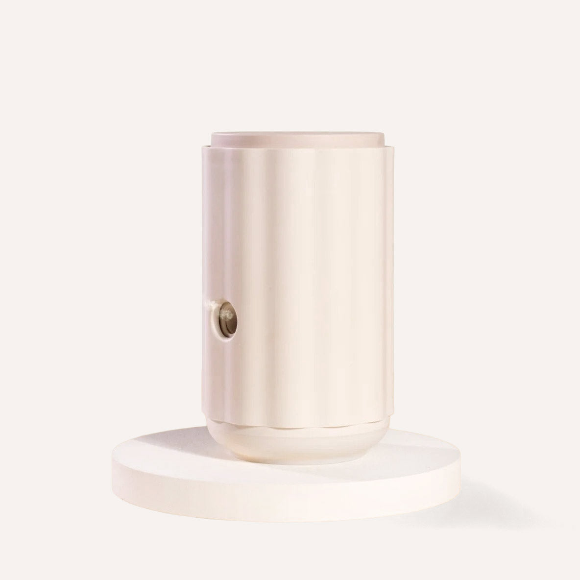 White cylindrical light fixture on a white background