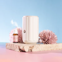 Aroma-Ascension Waterless diffuser. White diffuser with pink flowers 