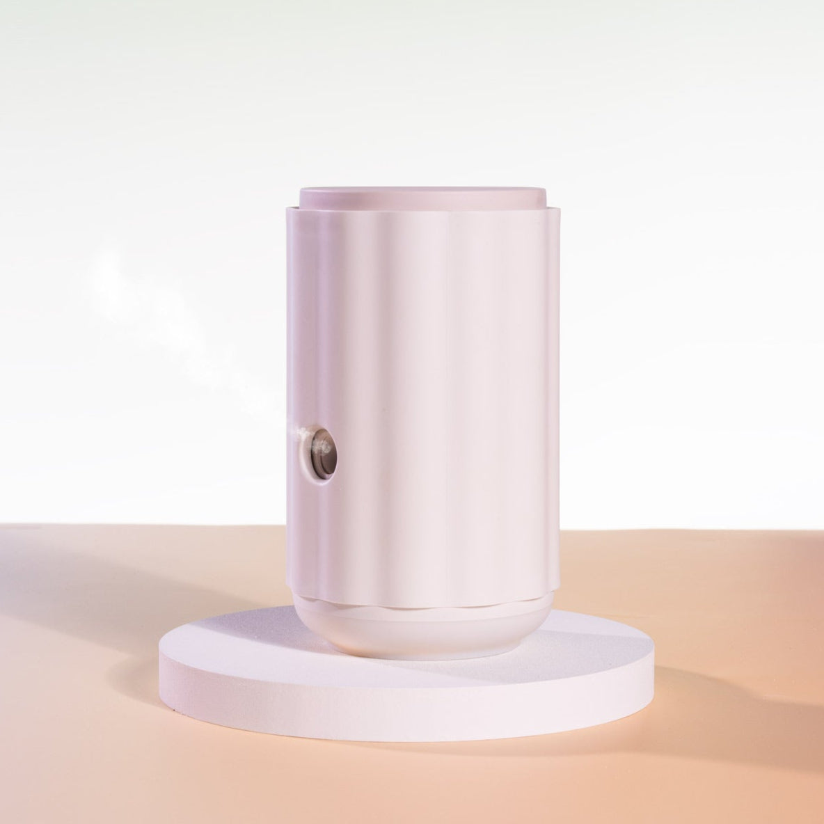 Aroma-Ascension Waterless diffuser. Pink cylindrical product on a white