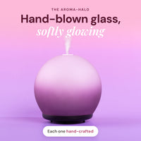 Aroma-Halo glass diffuser with matte glass cover glowing softly