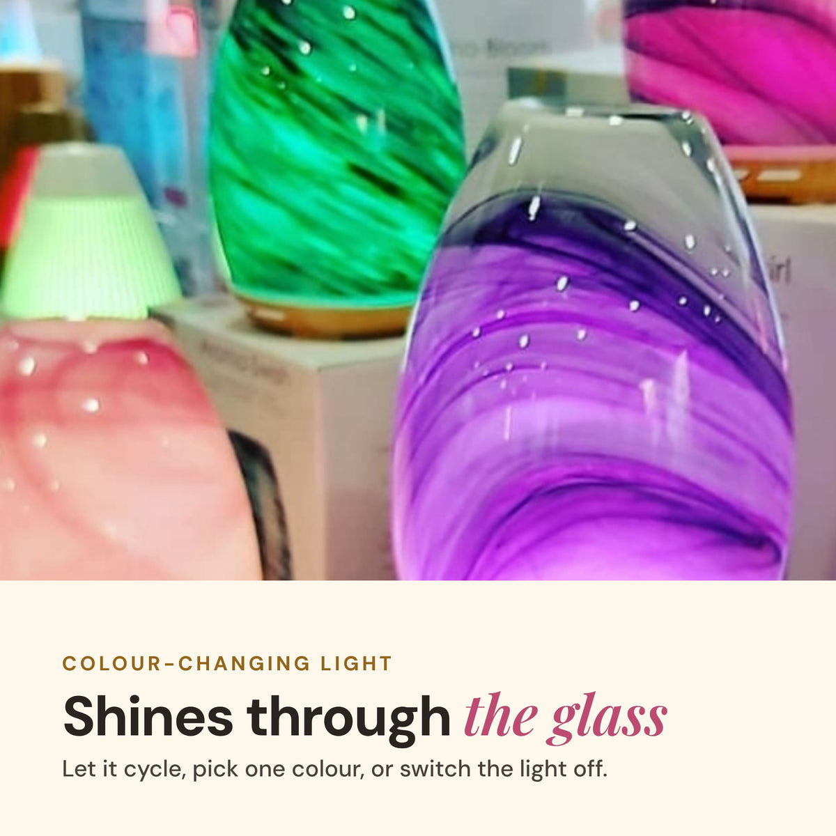 Aroma-Swirl glass diffusers glowing green, purple and pink, with the text Colour-changing light shines through the glass