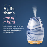 Blue swirl Aroma-Swirl glass diffuser misting on a navy background, headline A gift that's one of a kind, for birthdays, housewarmings and Christmas