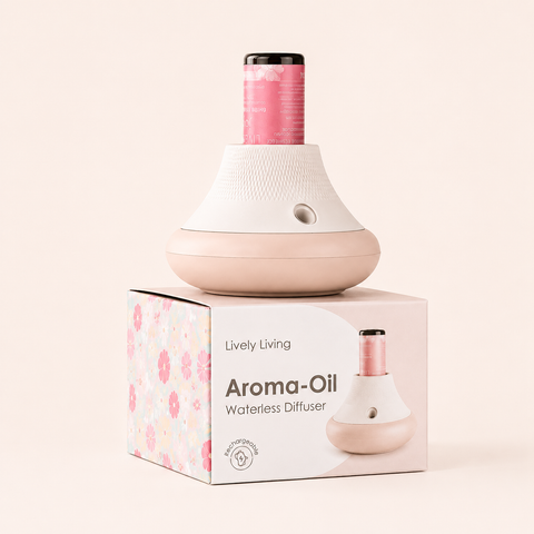 A waterless aroma-oil diffuser by Lively Living in a soft pink and white color scheme, displayed on top of its floral-patterned retail box against a solid pale beige background.