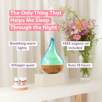 Decorative diffuser with text highlighting features on a table with flowers in the background