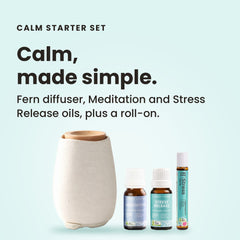 White ceramic Aroma-Fern diffuser with a bamboo lid beside Lively Living Stress Release and Meditation oils and a Stress roll-on, from the Aroma-Fern Calm Starter Set