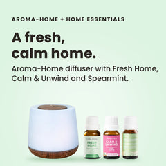 Aroma-Home diffuser with a ribbed white body and wood-look base beside Lively Living Spearmint, Fresh Home and Calm & Unwind oils from the Home Essentials Trio